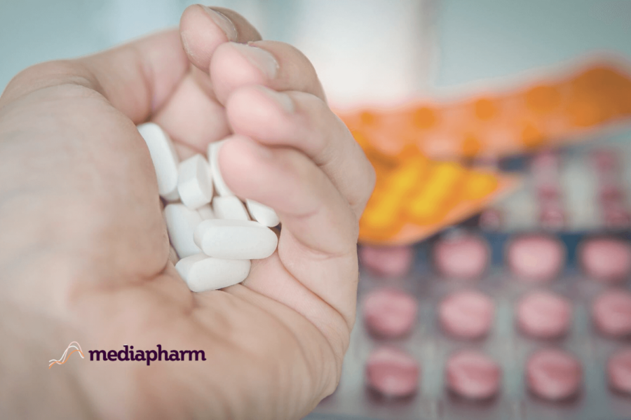 Dispensary Assistant Holding Medication